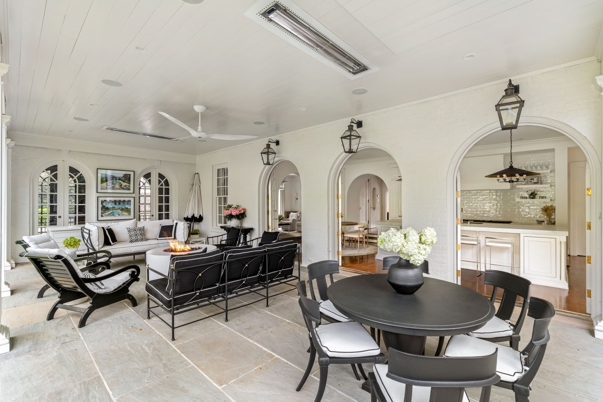 Luxury covered patio with arched doorways and elegant seating